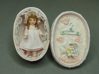 Doll in an oval box